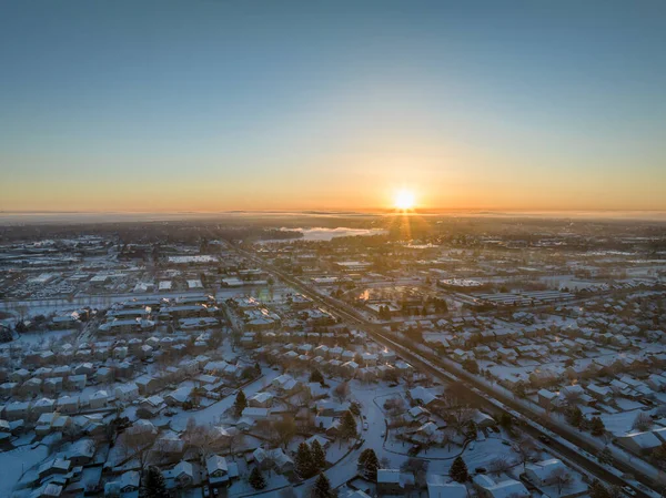 winter sunrise over Fort Collins and plains in northern Colorado, aerial view of residential streets and shopping centers