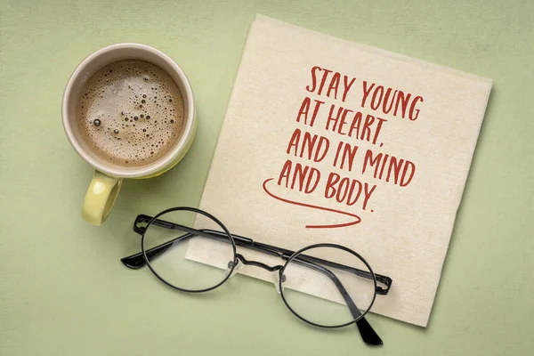 Stay young at heart, and in mind and body - inspirational note on a napkin. Healthy aging and personal development concept.