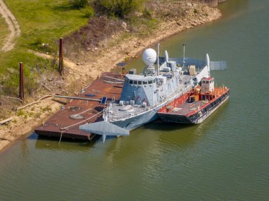 Gasconade, MO, USA - April 21, 2024: USS Aries (PHM-5), decommissioned Navy hydrofoil ship in an old boatyard at Confluence of Missouri and Gasconade Rivers. clipart