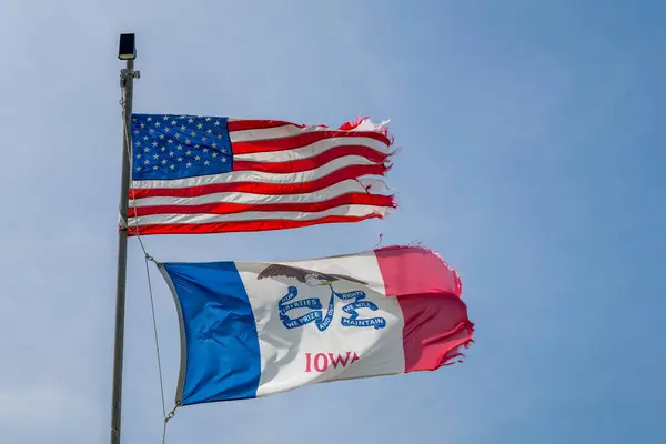 美国和爱荷华州的国旗自豪地在大风中飘扬 — 图库照片#