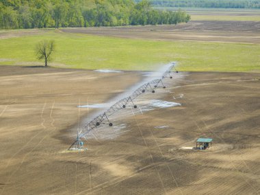 irrigation of farmland in a wide valley of the Missouri River near Wilton, MO, springtime aerial view clipart