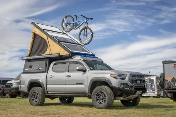 stock image Loveland, CO, USA - August 25, 2024: Super Pacific X1 camper on Toyota Tacoma, roof tent opened with a mountain bike on roof racks.