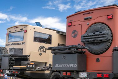 Loveland, CO, USA - August 25, 2024: Earthroamer expedition offroad vehicles: LTi on Ford F-550 chassis and SX on Chevrolet Silverado 6500HD chassis. clipart