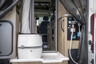 Loveland, CO, USA - August 25, 2024: Wet bath with a toilet in Winnebago Solis Pocket camper van. clipart