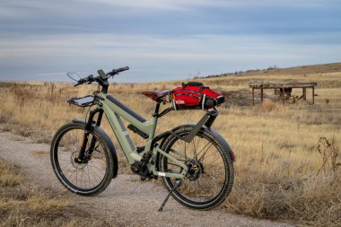 Loveland, CO, USA - February 2, 2025: Superdelite, advanced e-bike by Riese & Muller on a prairie biking trail in Colorado foothills. clipart