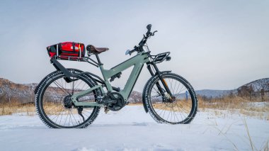 Bellvue, CO, ABD - 19 Şubat 2025: Superdelite, Riese Muller 'in gelişmiş tur e-bisikleti Colorado eteklerinin kış manzarasında valiziyle.