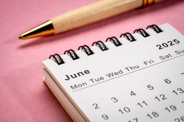 June 2025 - small spiral desktop calendar, time and business concept