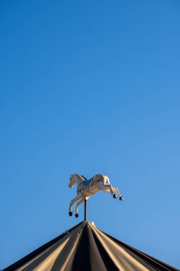 Horse on a carousel with blue sky in the background
