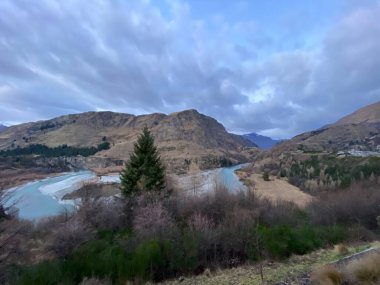 Photo of the Shotover River Kimiakau with Mount Aspiring viewed from Arthurs Point in Queenstown, Otago, South Island New Zealand. clipart