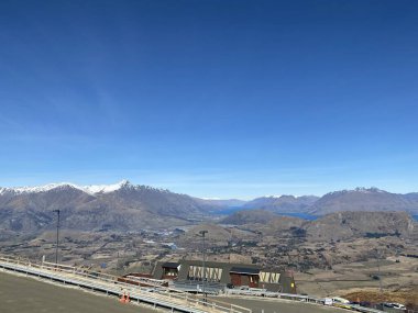 Photo of the Remarkables mountain range viewed from Coronet Peak in the Southern Alps viewed from Queenstown, Otago, South Island of New Zealand. clipart