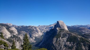 Photo of Half Dome viewed from Glacier Point in Yosemite National Park in central California, United States of America US.A  clipart