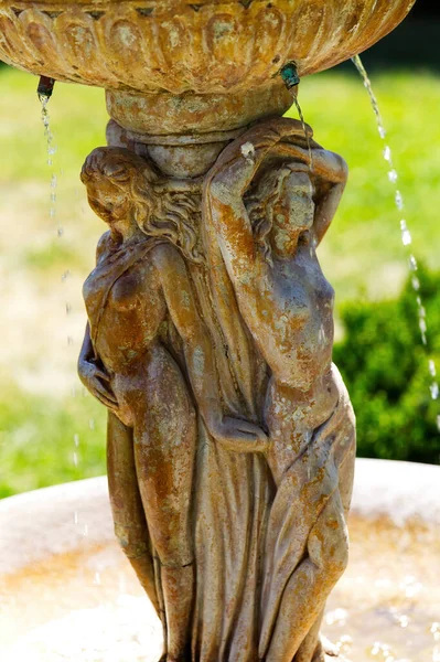 stock image Tight Shot Of Female Cement Figures On Fountain With Water Dripping Down