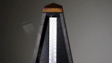 Close-up Shot Of Mechanical Metronome Arm Moving Back And Forth At Presto Tempo