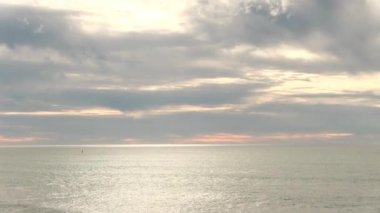 Handheld Camera Movement From Wide Ocean View Up Into Clouds