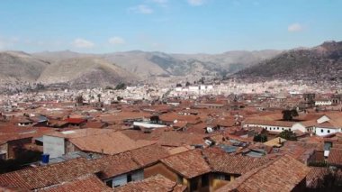 Handheld Camera Movement Left To Right Over Red Roofs Cusco Peru With Mountains And Blue Sky