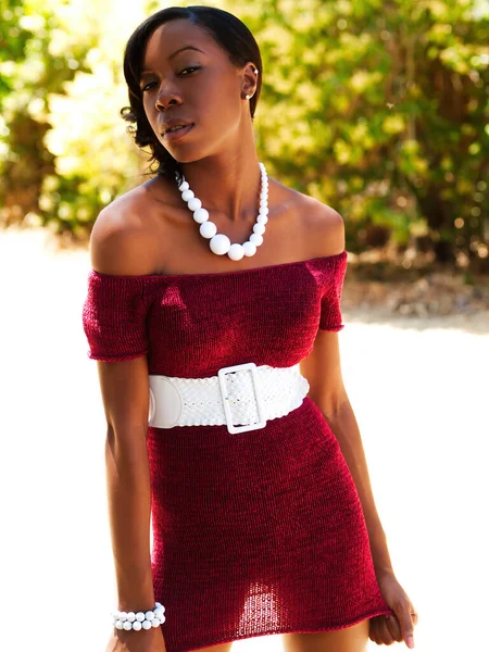 Slim Attractive African American Woman Outdoors Pulling Hem Red Dress — Stockfoto