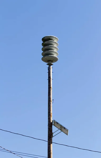 Old Tsunami Warning Siren Mounted Atop Pole Against Blue Sky Oregon