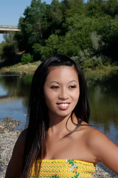 Азиатская Американка Улыбается Реке Желтом Платье Голые Плечи Открытом Воздухе — стоковое фото