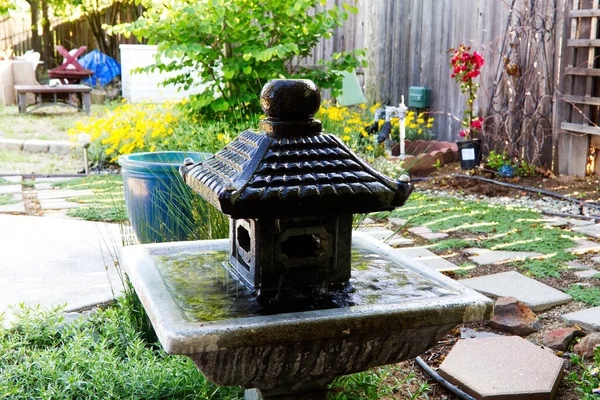 Yard Asian Pagoda Water Fountain Stone Path Flowers Plants Fence – stockfoto