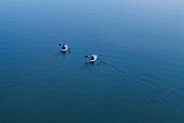 Two Men Blue Kayaks Backs Camera Calm Lake Showing Water — Stock Photo, Image