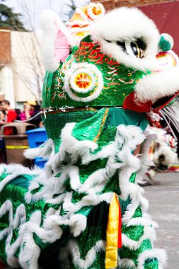 Çinli Aslan Dansçıları Küçük kasaba geçidinde Kalabalık Binası ve Sokak Arkaplanda Yürüyorlar