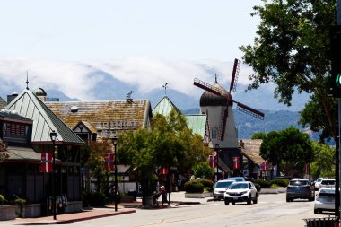 Solvang, California, ABD - 12 Haziran 2024: Yel Değirmeni Sokak Binaları Tepeleri Bulutlar ve Ağaçlar