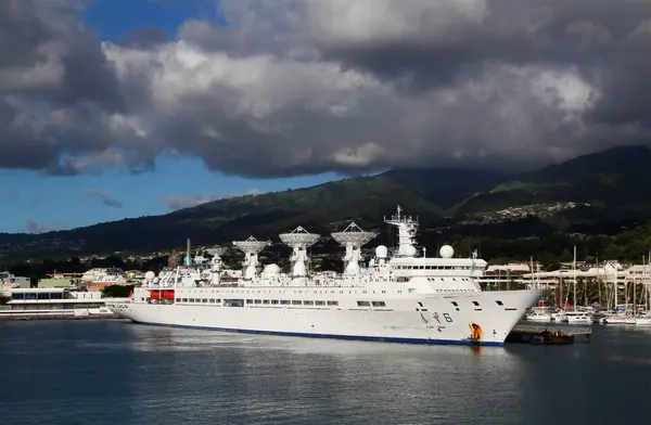 stock image Papeete, French Polynesia - May 13, 2024: Chinese Tracking Ship Yuan Wang 6 In Tahiti Harbor South Pacific With Green Hills And Gray Clouds
