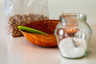 Bir poşet ballı cips, bir kase dolusu kaşık ve bir kavanoz şeker. Yan görünüm,