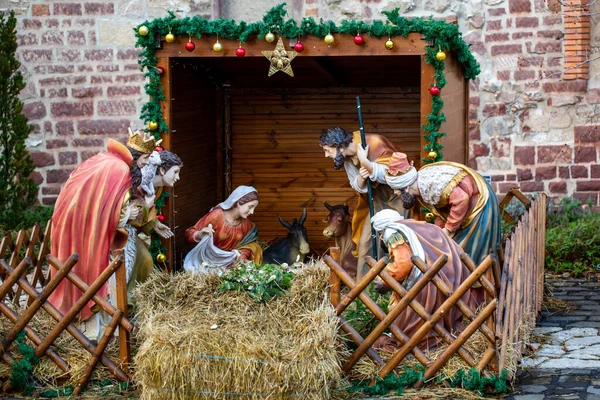 Christmas Manger scene with figurines including Jesus, Mary, Joseph, sheep and Magi.