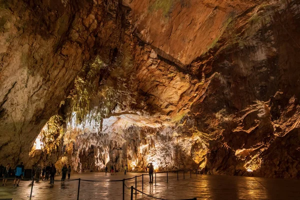 stock image Postojna, Slovenia - July 15, 2022: The Postojna Cave (Slovene: Postojnska jama) amazing interior, large chamber near the exit, underground rock formations in karst cave system.