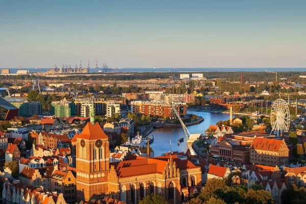 stock image City of Gdansk in Poland, cityscape with Church of St. John at sunset.