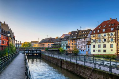 Petite France district in city of Strasbourg in Alsace, France. Picturesque historic quarter with flood gate and Alsatian style buildings at canal of River Ill. clipart