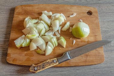 Kitchen knife and chopped onion.  Flat lay