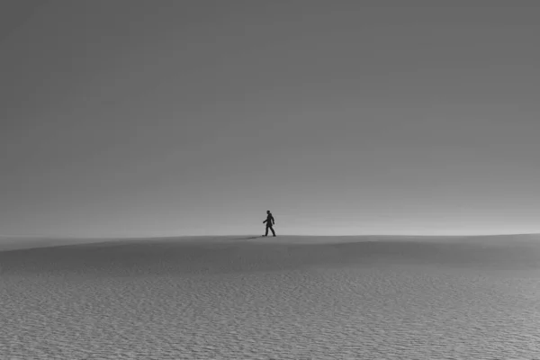 Silhouette of a person walking in the desert. 3d illustration