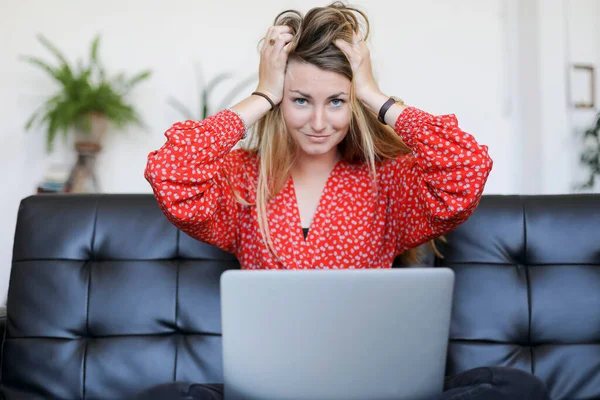 Blonde Woman Sitting Sofa Laptop Her Hands Her Head Looking — Stock Photo, Image