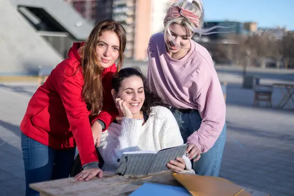 Three Young Women Gather Tablet Documents Engaged Group Study Session Stockbild