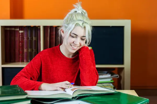 Young Woman Blonde Hair Smiling While Writing Notes Wearing Red Stockbild