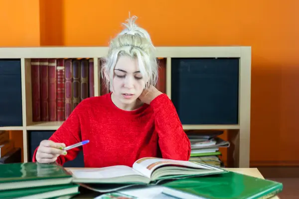 Young Woman Blonde Hair Smiling While Writing Notes Wearing Red Стокове Зображення