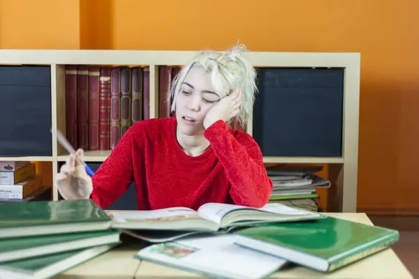 Young Woman Blonde Hair Looking Tired Holding Pen While Reading Ліцензійні Стокові Фото