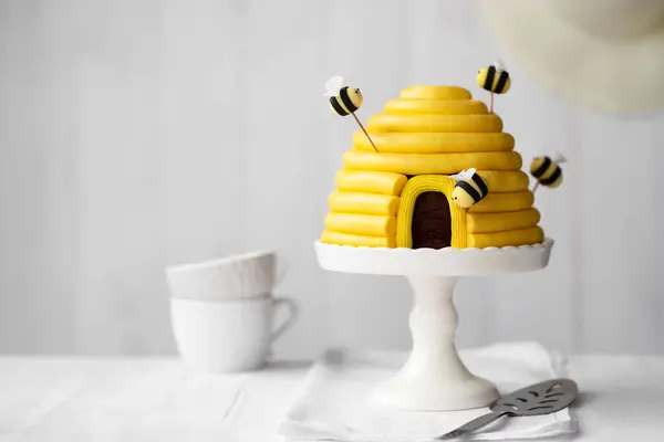 Beehive birthday cake with yellow buttercream and sugarpaste bees