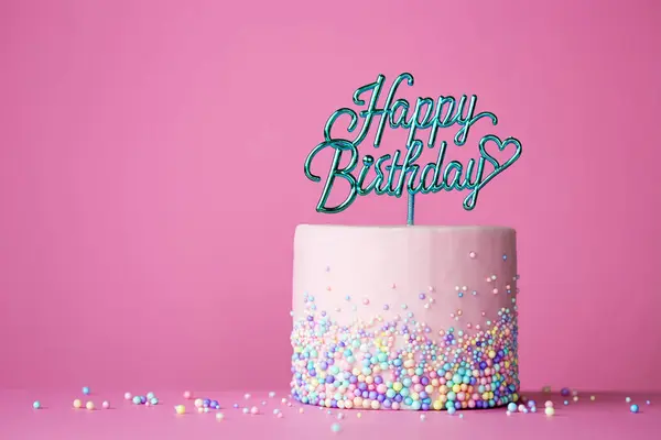 ピンクの背景にハッピーバースデーケーキピックでお祝いの誕生日ケーキ ストック画像