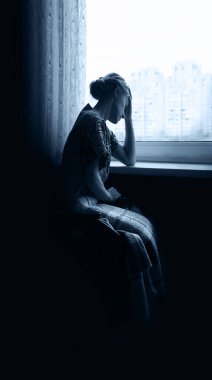 Adult poor sick ill holy devote lady seat dark old cold home room light white war city sky text space. sullen fail fear frown sit teen human face beg hand ask god Jesus Christ wait love hope concept