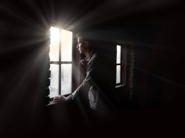 Old retro antique life young teen age frown boy guy face feel guilt light sky view. ancient lost tire guilty human cry ask belief god lord Christ love faith hand dark black room text space war concept