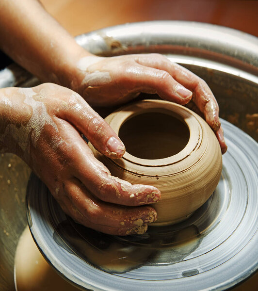 Closeup rural bible god male artisan worker dirty arm touch tool teach ancient retro old earthen culture water mug pitcher vessel ware. Rustic antique wet hobby table girl learn make pan dish design