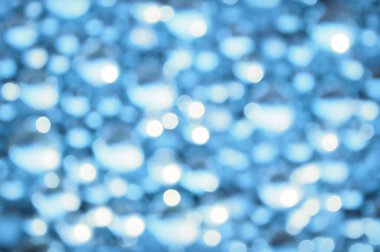 Awe beautiful christmaslight twinkly blue color dust glitz card copyspace area. Bright glittery de focus art soft sphere shape. Close-up view with space for text on dark cobalt merry xmas glowball scene