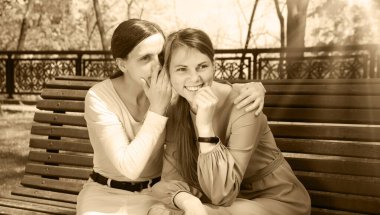 İki güzel yetişkin bayan, yaz kenti şehir merkezindeki ağaçlık alanda yalan söylüyor. Gençlik ilişkisi yalancısı. Bak, neşeli neşe şoku. Gülümse.