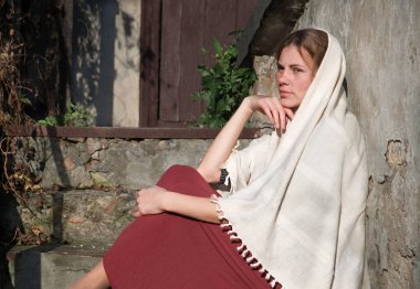 Young adult age jew poor slave human white sun folk veil shawl scarf cloth sad lone teen lady face think pray. Wait god smile love faith see relax sunny day old bible barn hut outside park step seat