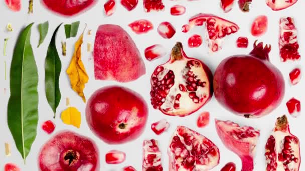Granatapfelfruchtstücke Scheiben Und Blätter Werden Isoliert Auf Weiß Nach Oben — Stockvideo