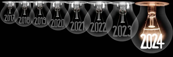 Horizontal group of shining light bulb with fiber in a shape of New Year 2024 and dimmed light bulbs with years passed isolated on black background.