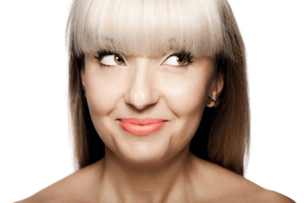 Close up portrait of a beautiful brunette girl with blond bangs fringe. Positive face expression